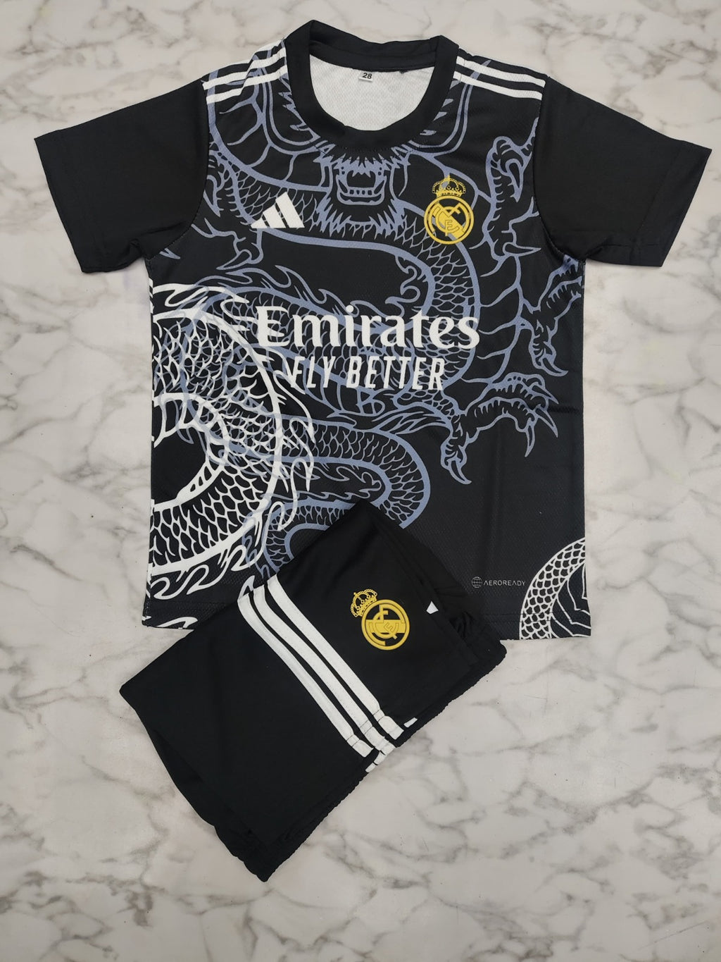 Real Madrid Black Dragon 25/26 Kids India Football Jersey Set (Jersey + Shorts)